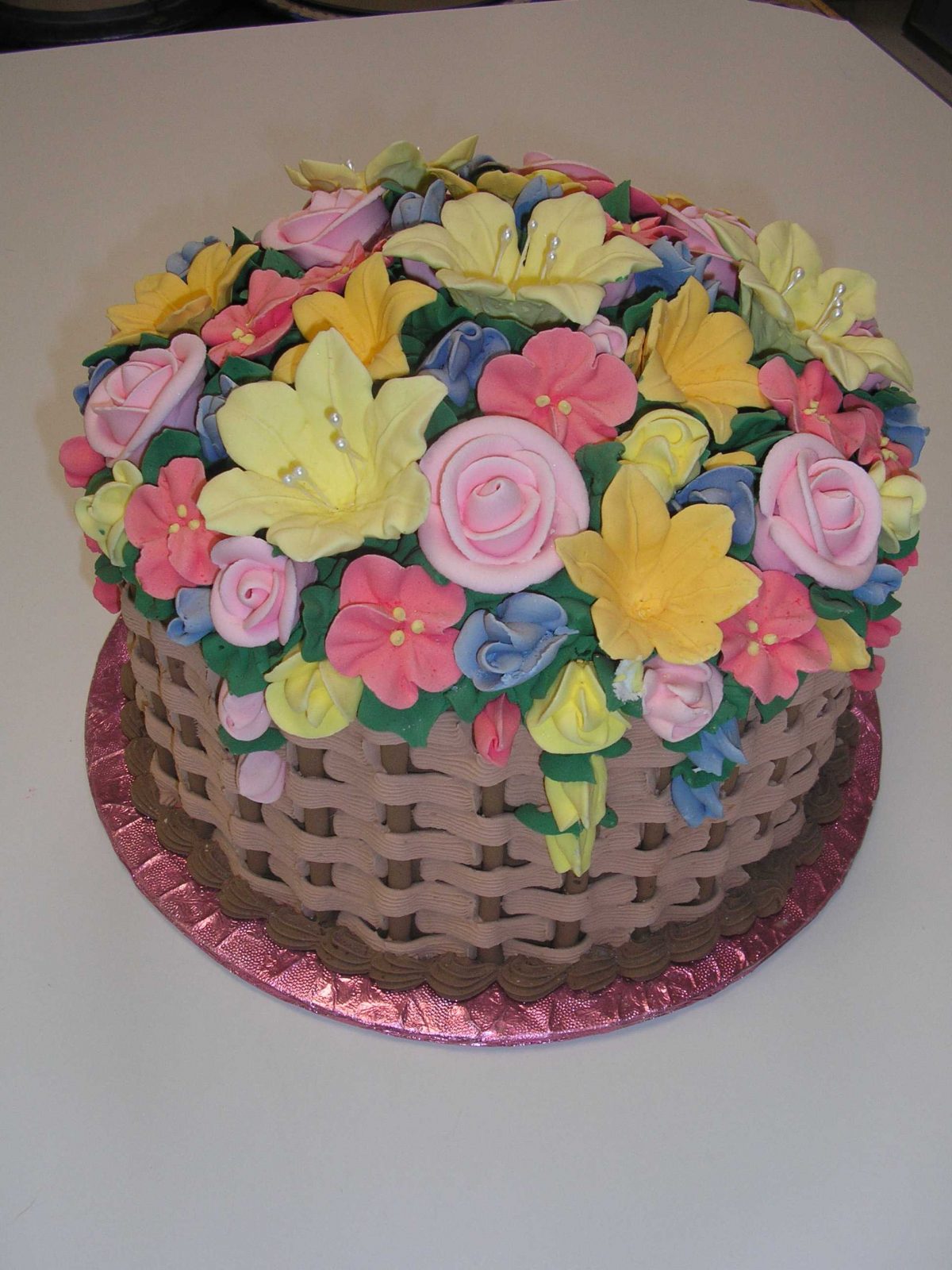 gift basket cake with mound of flowers covering top