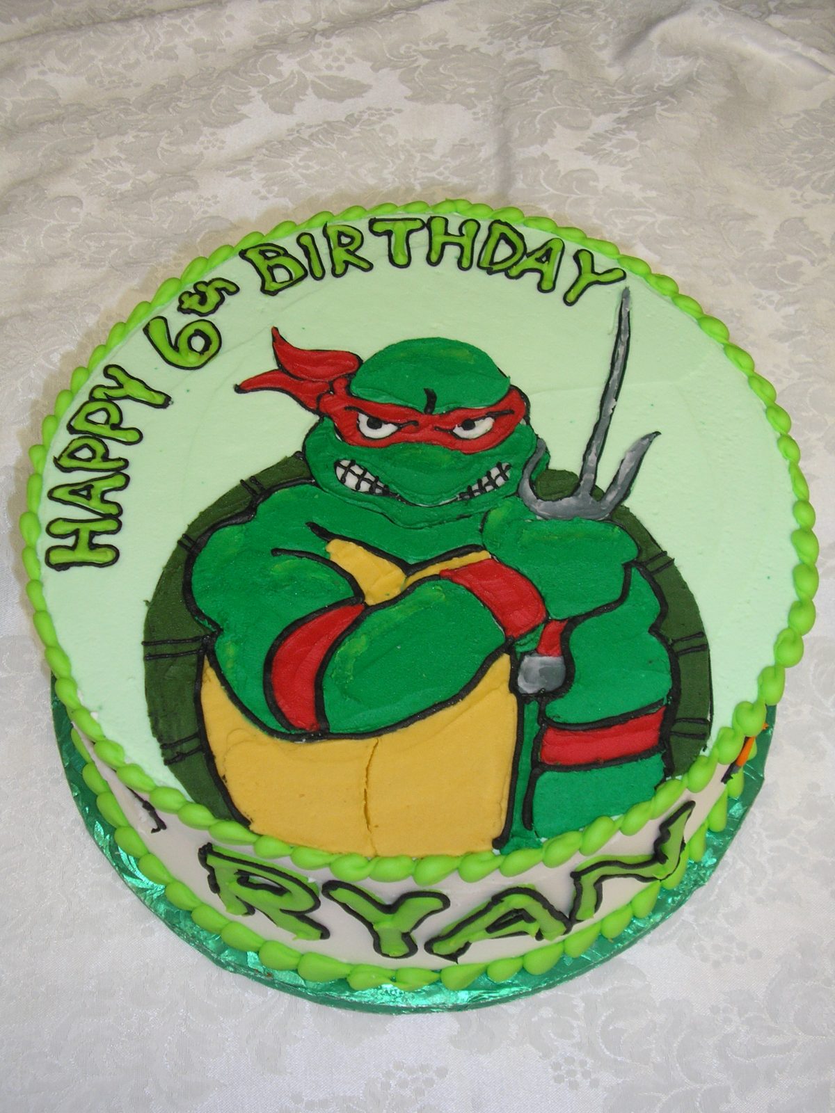 icing drawing of a ninja turtle on a cake