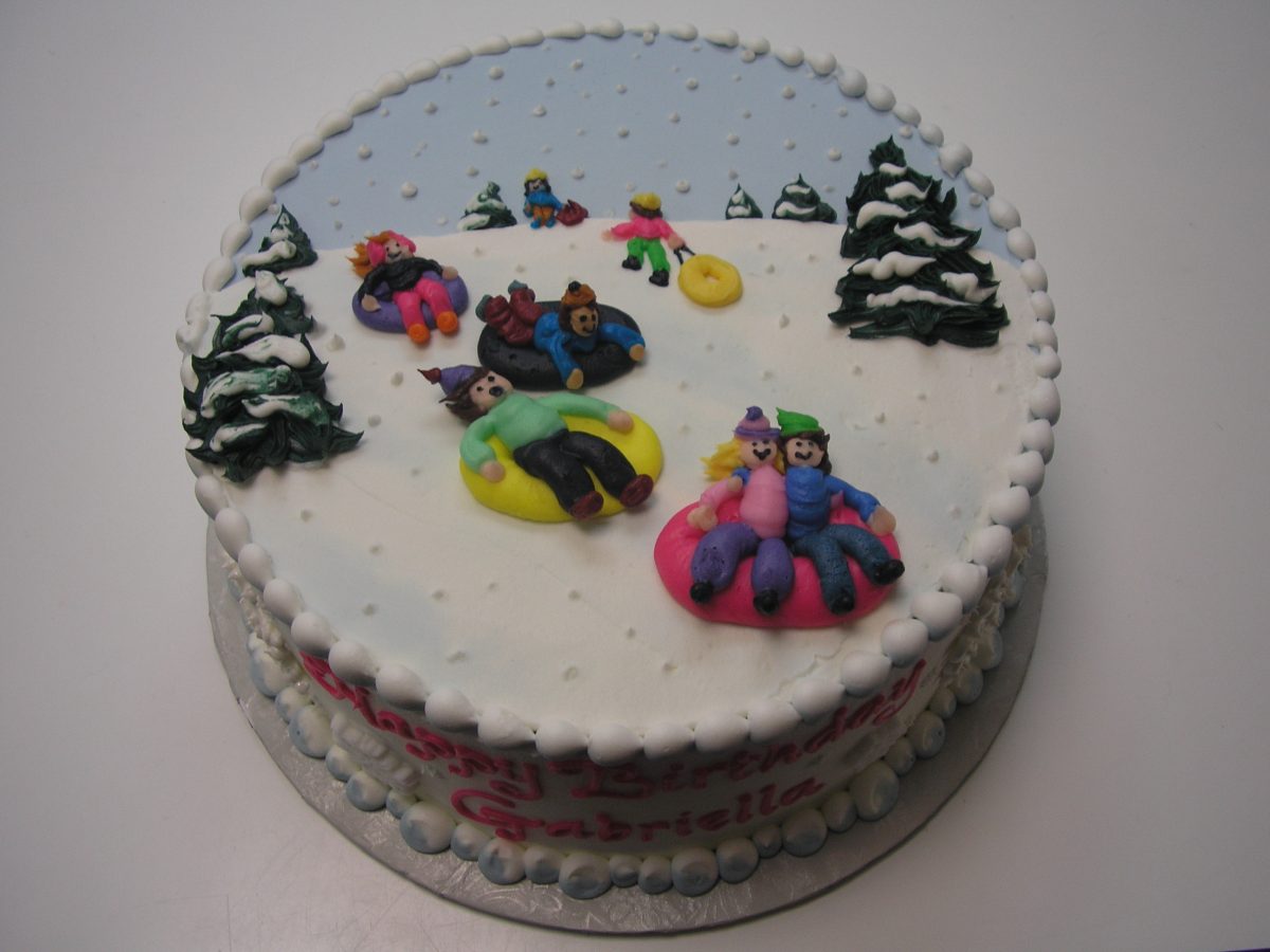 piped on sleds on cake